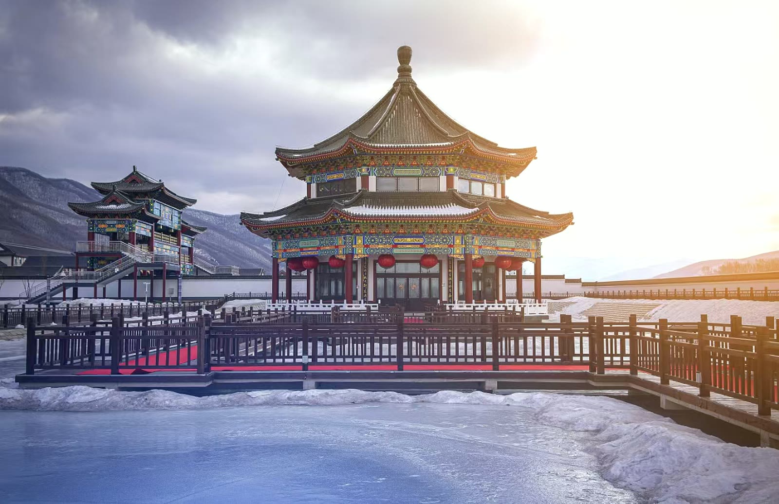 Palace-style Haoji brewery hall with painted eaves, snowy mountains and traditional courtyard railings